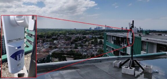 An image of a mesh network antenna on a roof in Toronto. A closeup cutout of the antenna shows a sticker that says “Property of Toronto Mesh.” (Image courtesy of Toronto Mesh)