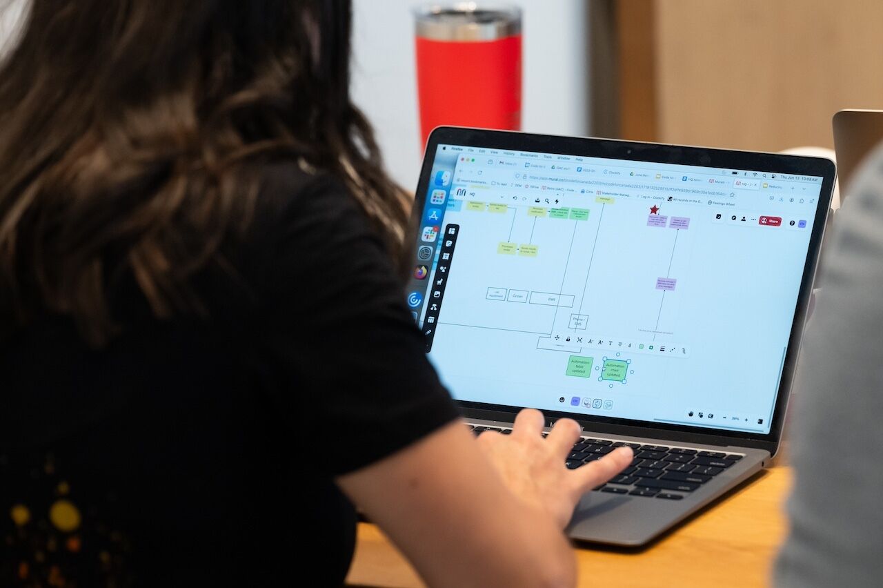 Over-the-shoulder view of laptop with a user journey map