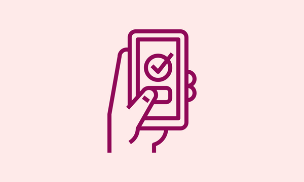 A hand holding a smartphone with a check mark on it