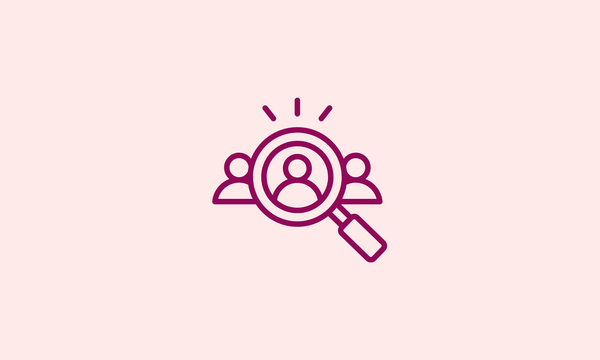 An icon of a magnifying glass hovering over three people