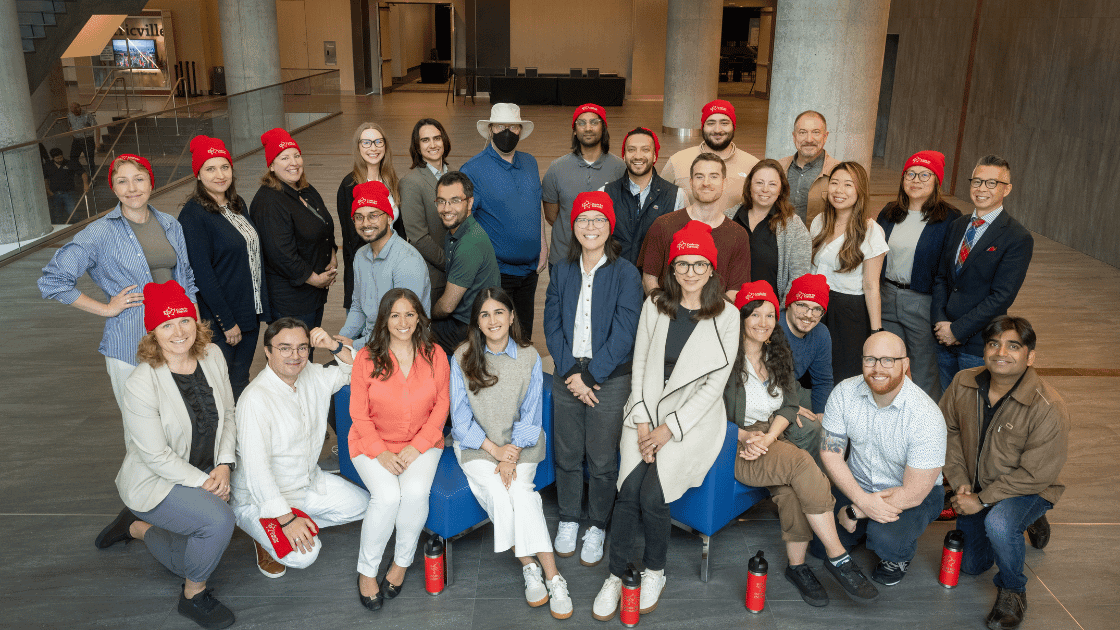 A group photo of 27 Code for Canada staff smiling at the camera1